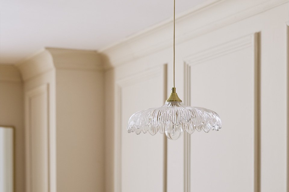 Petal glass brushed brass pendant in a dining room.